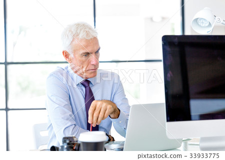 Businessman at the office Businessman at the office 33933775