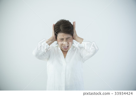 Senior woman annoyed stress headache 33934424