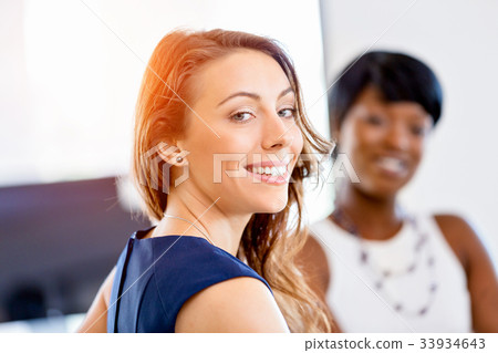 Women working together, office interior 33934643