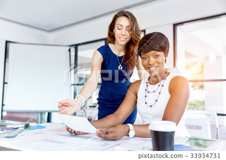 Women working together, office interior Women working together, office interior 33934731