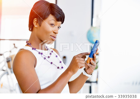 Portrait of smiling business woman with mobile 33935038