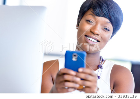 Portrait of smiling business woman with mobile Portrait of smiling business woman with mobile 33935139