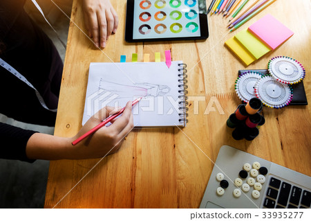 young women working as fashion designer drawing sketches for clo young women working as fashion designer drawing sketches for clo 33935277