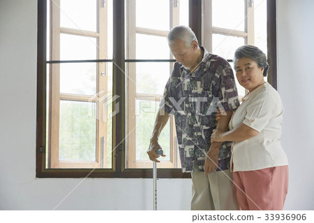 grand mother is looking after her husband on bed 33936906