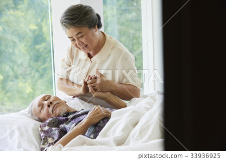 a photo of old grand mother helping her husband walking upstairs 33936925