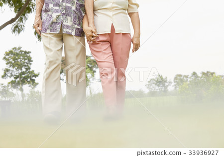 two elderly people are sitting chatting together inside house 33936927