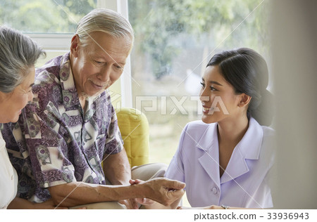 a nurse is showing something for elderly man 33936943