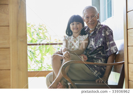 photo of a grandfather and a child sitting on bench and smiling photo of a grandfather and a child sitting on bench and smiling 33936962