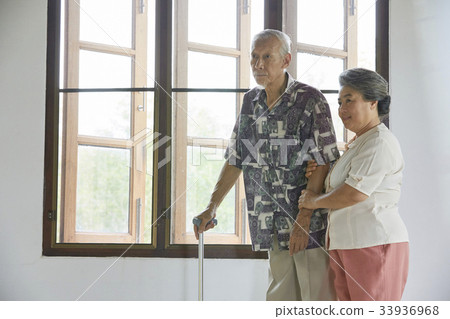 senior couple is walking and looking at something indoors 33936968
