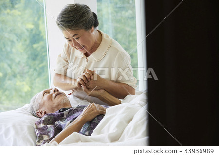 A happy senior couple is holding hands at room 33936989