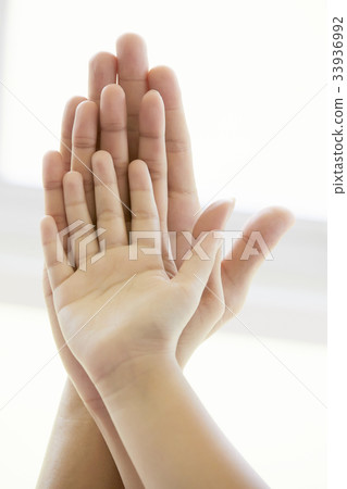 A photo of three hands of parents and a child 33936992
