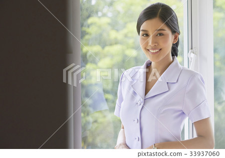 A beautiful nurse in white blouse is smiling A beautiful nurse in white blouse is smiling 33937060