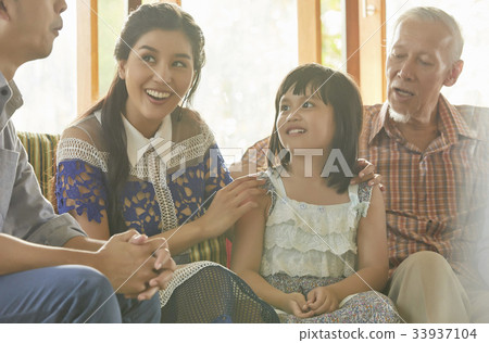 a happy extended family is talking and having fun together. 33937104