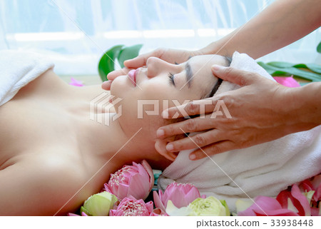Happy relax woman getting facial massage at salon. 33938448