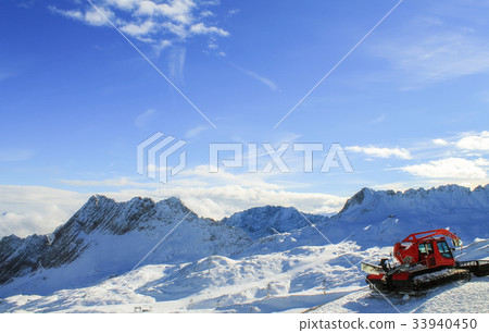 View of a mountain range with snow and clouds View of a mountain range with snow and clouds 33940450