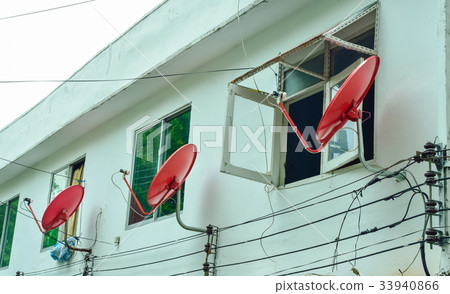 Red dish satellite receiver side of old apartment Red dish satellite receiver side of old apartment 33940866
