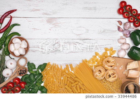 Italian pasta ingredients on wooden table top view Italian pasta ingredients on wooden table top view 33944486