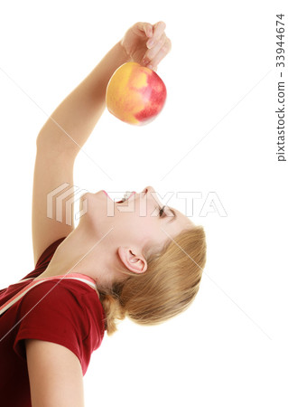 housewife in kitchen apron eating apple healthy fruit housewife in kitchen apron eating apple healthy fruit 33944674