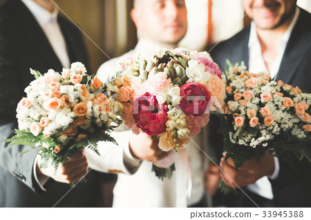 Grooms morning preparation. Handsome man getting Grooms morning preparation. Handsome man getting 33945388
