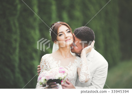 Romantic, fairytale, happy newlywed couple hugging 33945394