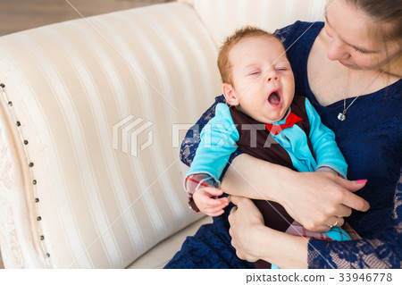 Tired newborn baby boy yawns Tired newborn baby boy yawns 33946778