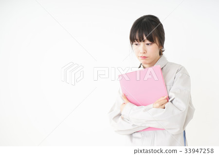 Woman in working clothes working in a factory Woman in working clothes working in a factory 33947258