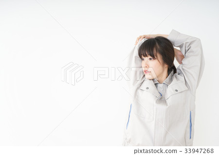 Woman in working clothes working in a factory Woman in working clothes working in a factory 33947268