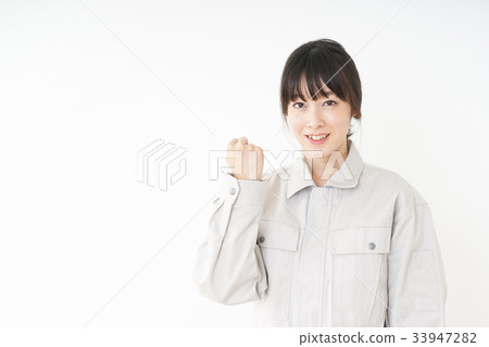 Woman in working clothes working in a factory 33947282