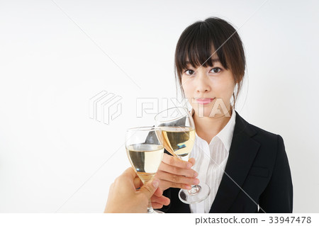 Young woman drinking alcohol in a suit Young woman drinking alcohol in a suit 33947478