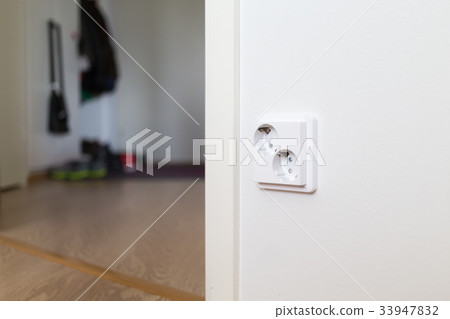 White wall socket on wall. 33947832