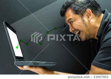 Asian man and computer stock market graph growth 33947903