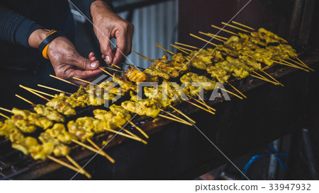 Pork satay with peanut sauce at street food market 33947932