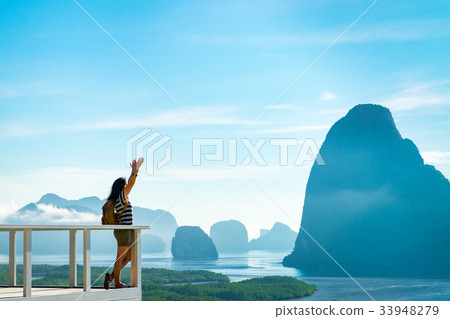 traveler woman backpacker raised arm up to sky 33948279