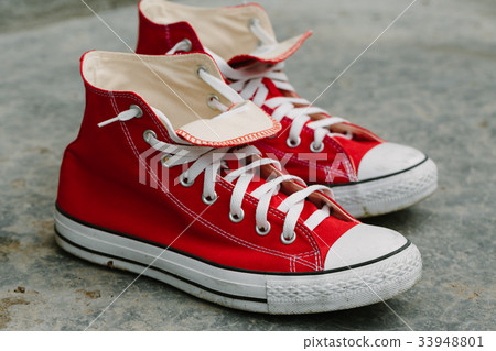Pair of red shoes on concrete. 33948801