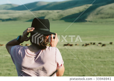 Photographer holds a camera and photographs. 33948941