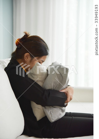 Business woman in Yellow shirt sitting on sofa. 33949193