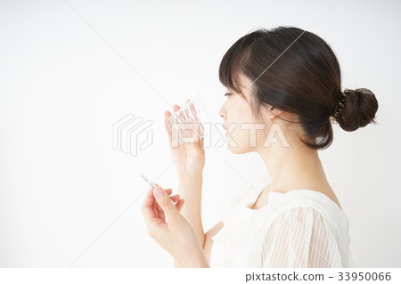 Young woman taking oral medicine Young woman taking oral medicine 33950066