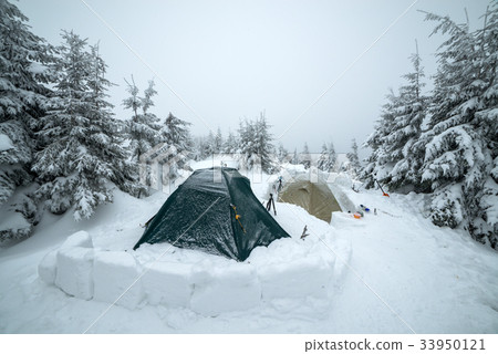 Frozen tents in the high mountain 33950121