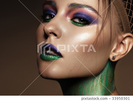 Beautiful girl with creative colorful makeup Beautiful girl with creative colorful makeup 33950301