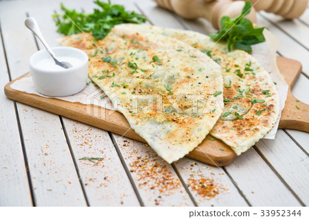 Typical Turkish meal Gozleme with herb and cheese. Typical Turkish meal Gozleme with herb and cheese. 33952344