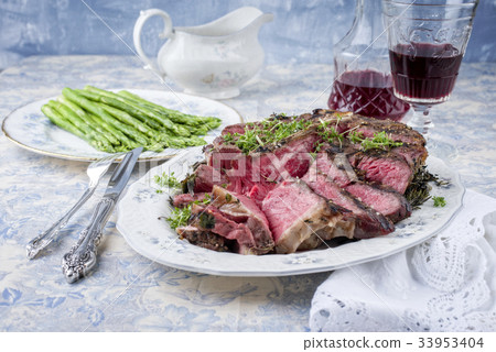 Sliced Porterhouse Steak with Green Asparagus on P 33953404