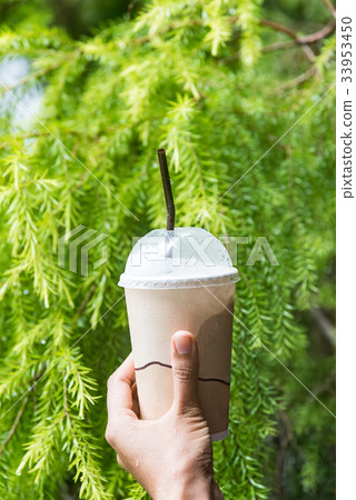 Woman hand is holding an cold coffee cup. Woman hand is holding an cold coffee cup. 33953450
