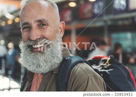 Old man demonstrating cheerfulness in airport Old man demonstrating cheerfulness in airport 33953451