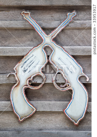 Crossed Pistols on wood background 33953917