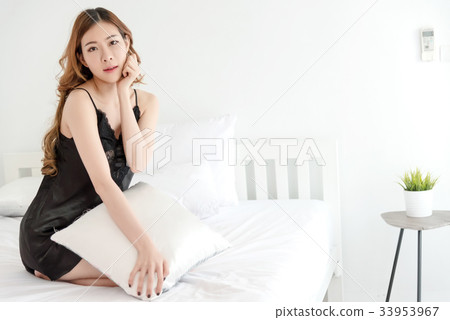 Sexy asian slim woman posing in bedroom Sexy asian slim woman posing in bedroom 33953967