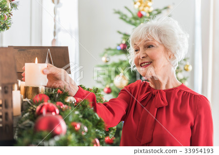 Elegant senior lady is preparing for New Year Elegant senior lady is preparing for New Year 33954193