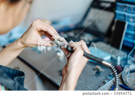 The girl is engaged in jewelry business 33954771