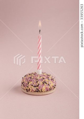 birthday cake with one candle on pink birthday cake with one candle on pink 33955263