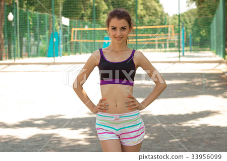 slim girl stands up straight smiles and keeps slim girl stands up straight smiles and keeps 33956099