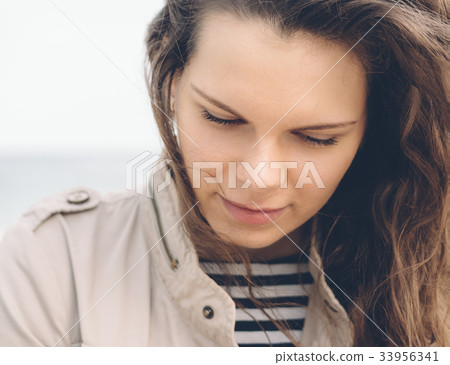 Portrait of young woman with curly hair Portrait of young woman with curly hair 33956341